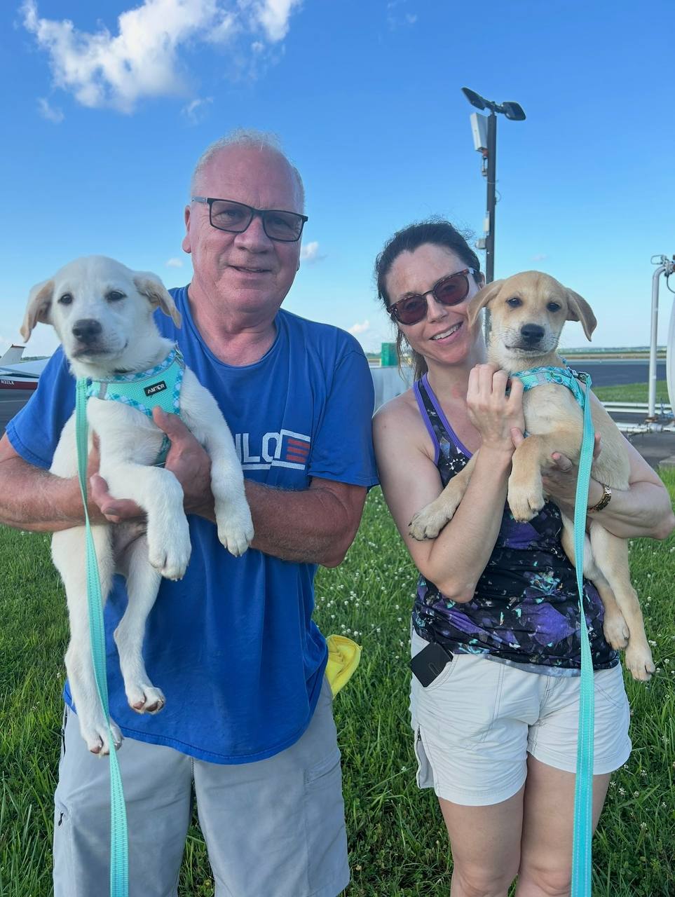 People holding rescue dogs after a safe landing